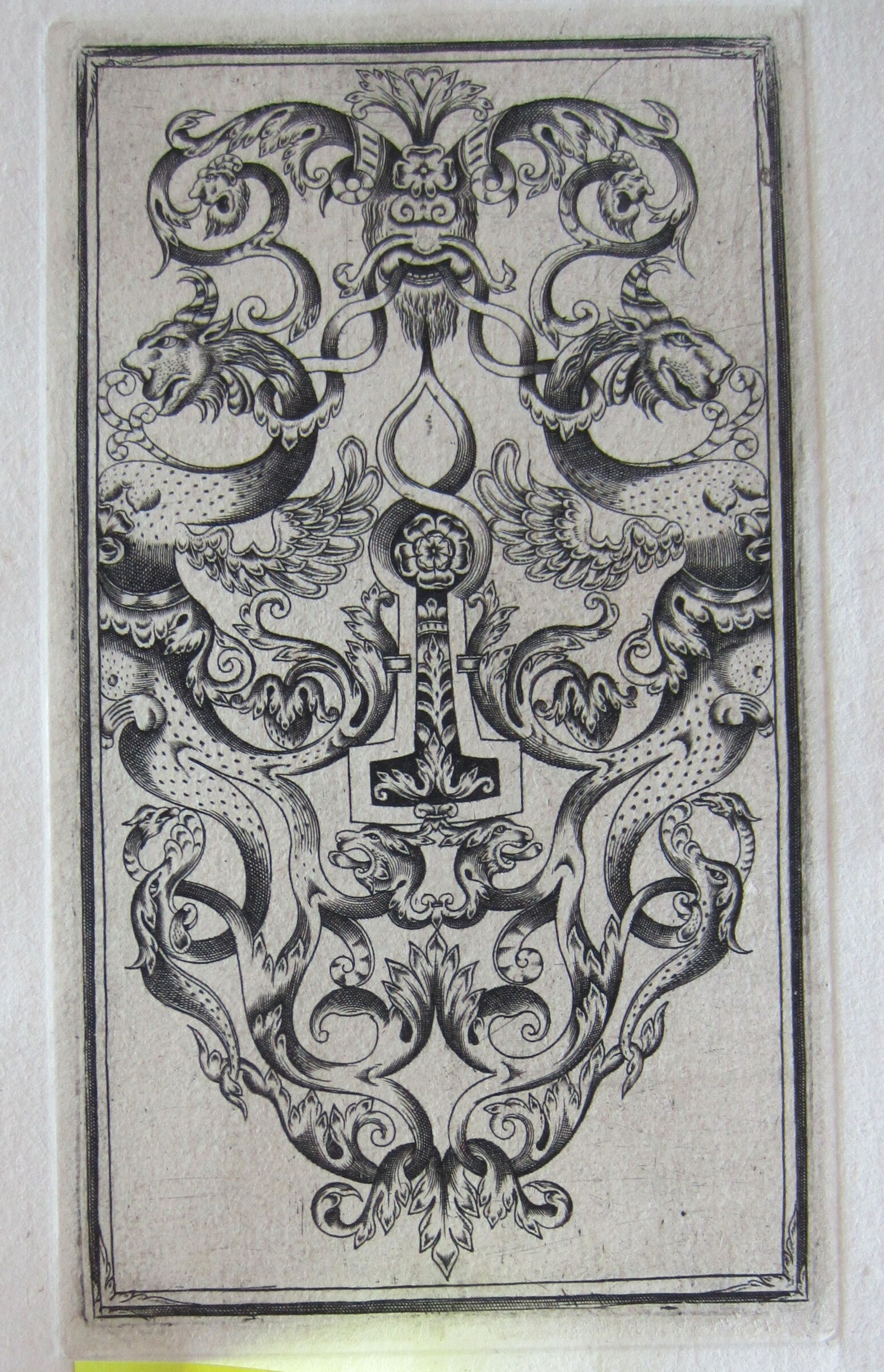 Escutcheon With A Keyhole With A Blooming Rose Flanked By Winged Dappled Female Monsters With Leonine Heads
