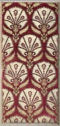 A rectangular piece of velvet fabric with a large floral pattern covering the whole fabric. The background is dark red and the pattern is made of large, white circular floral motifs with two leaves at the bottoms.