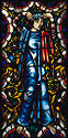 A stained-glass window panel of a woman with animals and floral designs.