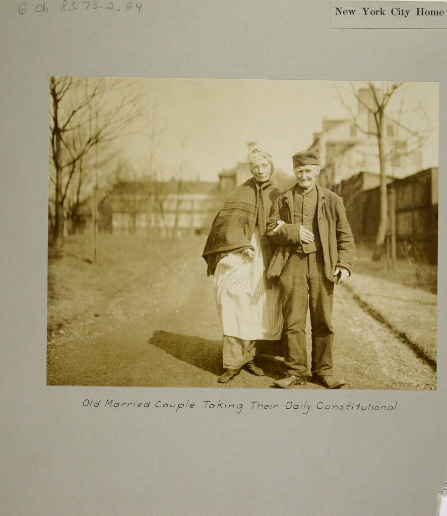 Charity, Aged: United States. New York. New York City. Home For Aged And Infirm, Manhattan Division, Blackwell's Island: New York City Home For The Aged And Infirm: Old Married Couple Taking Their Daily Constitutional.