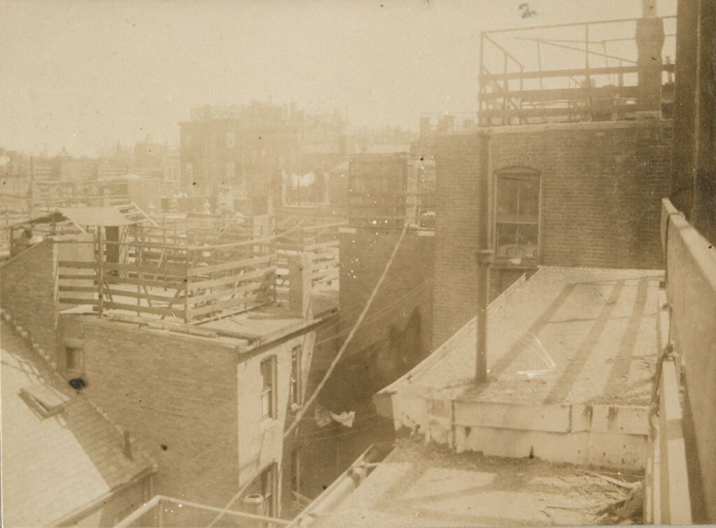 Housing, Conditions: United States. Massachusetts. Boston. Alleys; Tenements; Yards: Housing Conditions: Boston: Views From Roofs Of Poplar St. Block Showing Unkempt Fences Shed & Litter Not Suggested By The Model.: From 71 Poplar St: Looking So.e. Toward Spring St: 1911.