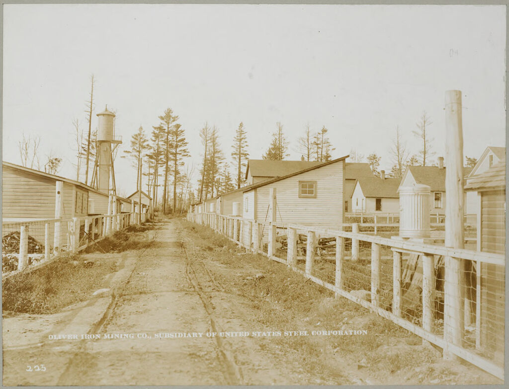 Housing, Industrial: United States. Minnesota: Industrial Housing In Mining Villages. Alleys: Oliver Iron Mining Company. Subsidiary Of The United States Steel Corporation: I. Hibbing District, Hibbing, Minn.  Alley In Mining Location.  Showing Garbage Cans And Woodsheds.
