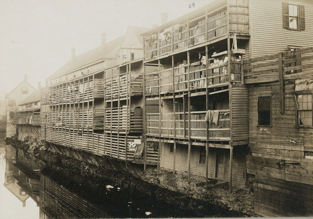 Housing, Conditions: United States. Massachusetts. Lowell. Tenements In French, Greek, And Polish Districts: Environments After Immigration. Perpetuation Of European Standards In America. Housing Conditions, Lowell, Mass.: Suffolk St. Frame Tenements Occupied By Greeks, Irish, Jews. Dangerous Galleries Overhanging The Canal From Broadway Bridge.