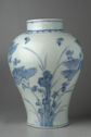 A wide, circular jar with blue decorations on white porcelain