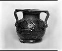 Black and white image of opaque rounded amphora with two handles, short neck, wide flat lip, and etched pattern decorations  