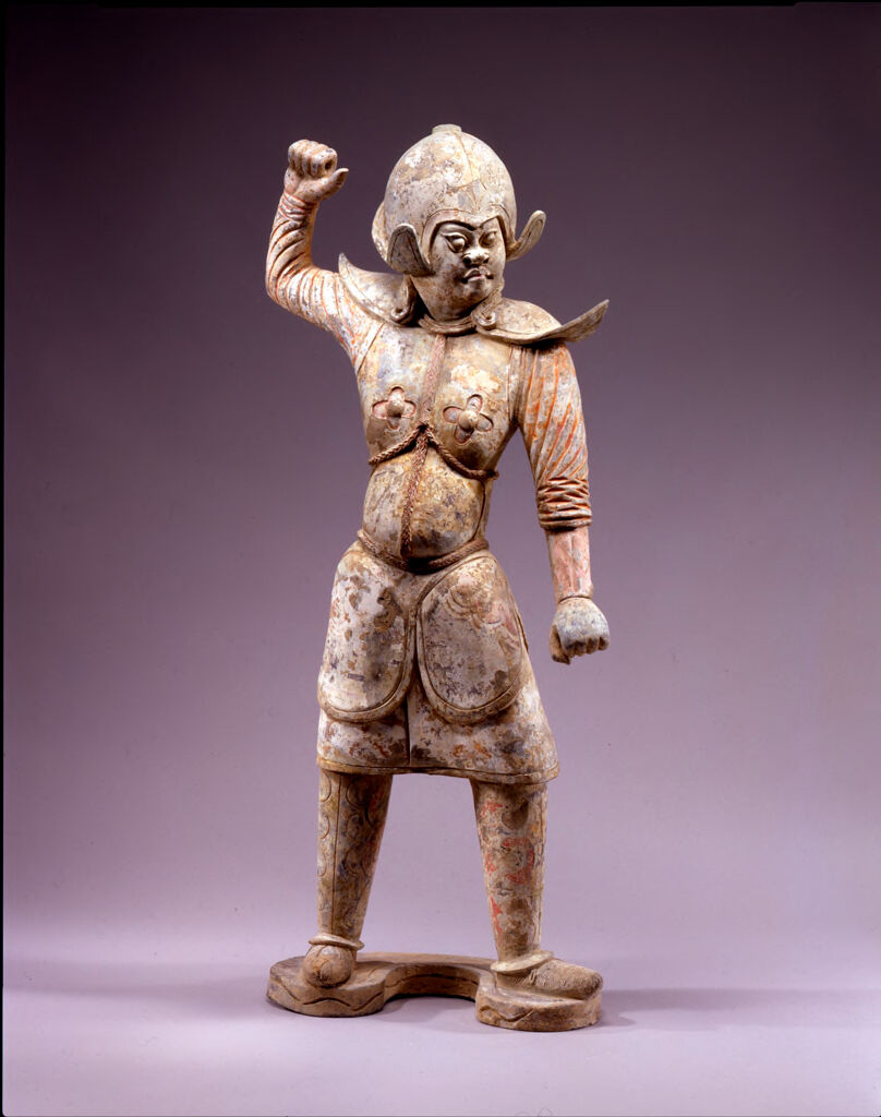 Pair Of Standing, Helmeted, Armor-Clad Guardian Warriors, Each With One Arm Raised And One At The Side, And Both Hands Clenched As If Holding Weapons, One Figure With Mouth Closed And Wearing Straw Shoes, One With Mouth Open And Wearing Pointed Boots