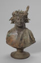 The bust of a figure with an elaborate headdress.