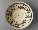 Cream-colored bowl with black painted decoration