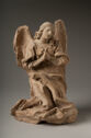 Terracotta statue of a kneeling, winged figure with hands pressed together