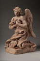 Terracotta statue of a kneeling, winged figure pressing fabric to their chest