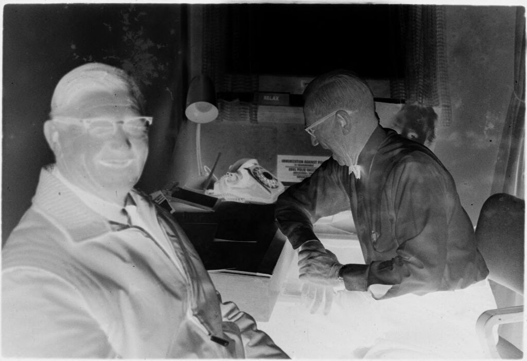 Untitled (Dr. Herman M. Juergens And Patient In Exam Room With Patient Smiling Toward Camera)