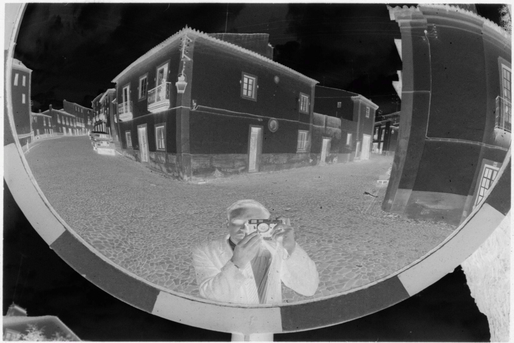 Untitled (Reflection Of Gordon Gahan And The Intersection Of Stone Streets In Convex Mirror, Nazaré, Portugal)