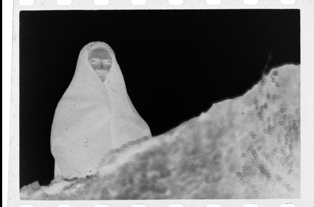 Untitled (Female Cowherd Wrapped In Blanket Standing Above Small Ledge, Nazaré, Portugal)