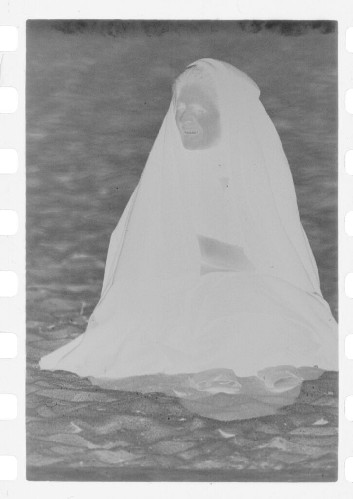 Untitled (Old Woman Wrapped In Shawl Sitting On Beach, Nazaré, Portugal)