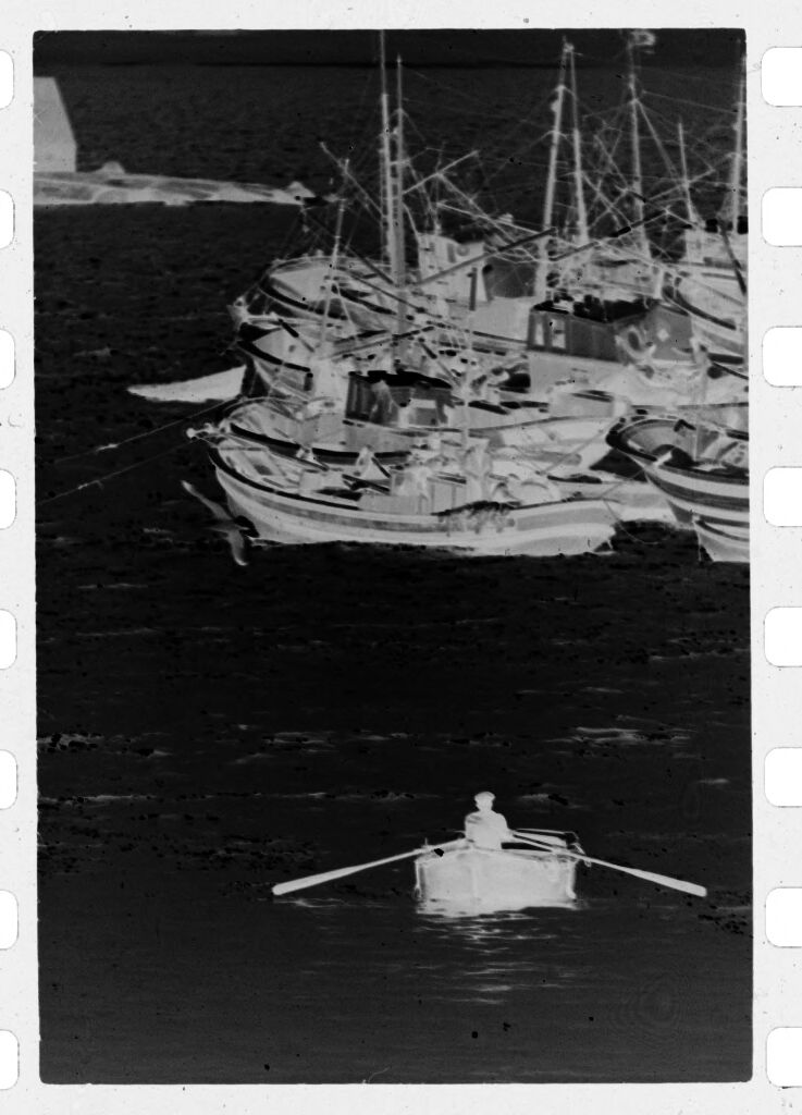 Untitled (Fisherman In Rowboat Rowing Toward Fishing Vessels, Nazaré, Portugal)