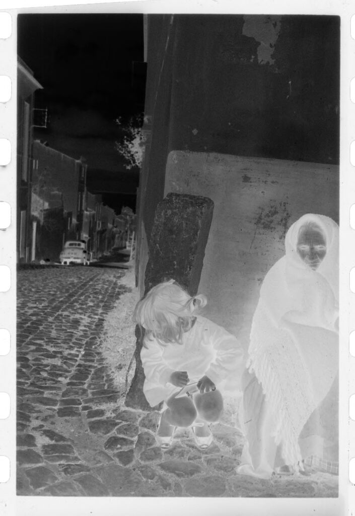 Untitled (Woman And Young Girl Crouched Against Side Of Building, Nazaré, Portugal)