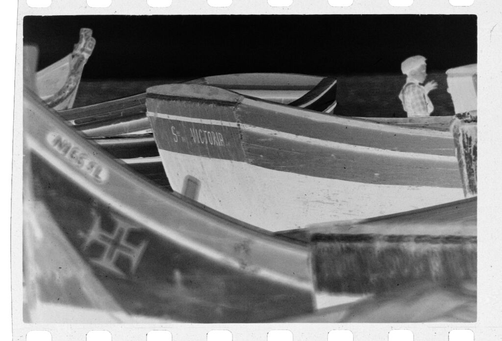 Untitled (Fishing Boats On Beach With Young Boy Standing Behind Boat In Background, Nazaré, Portugal)