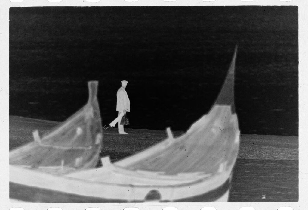 Untitled (Fishing Boats On The Beach With Man With Umbrella In Background, Nazaré, Portugal)
