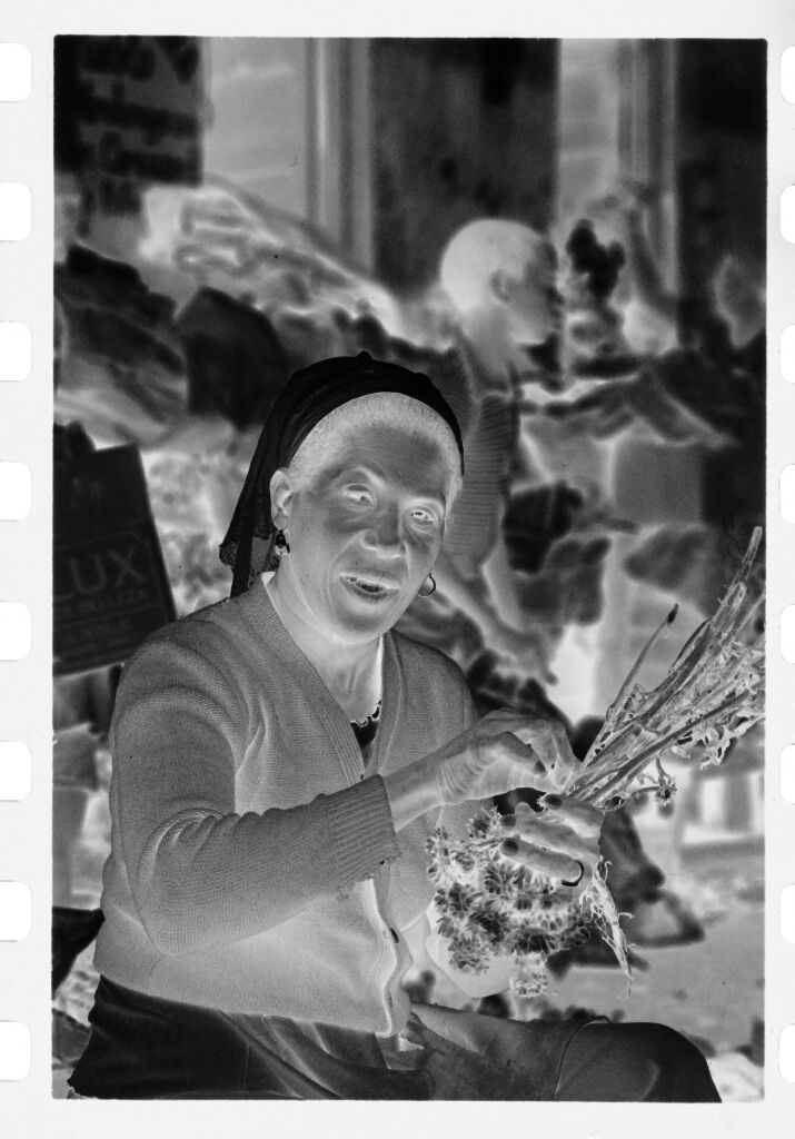 Untitled (Woman Wearing Headscarf And Sweater Bundling Flowers To Dry)