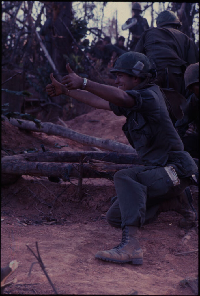 Untitled (Soldier Facing Left Kneeling On Ground And Giving Two Thumbs Up, Vietnam)
