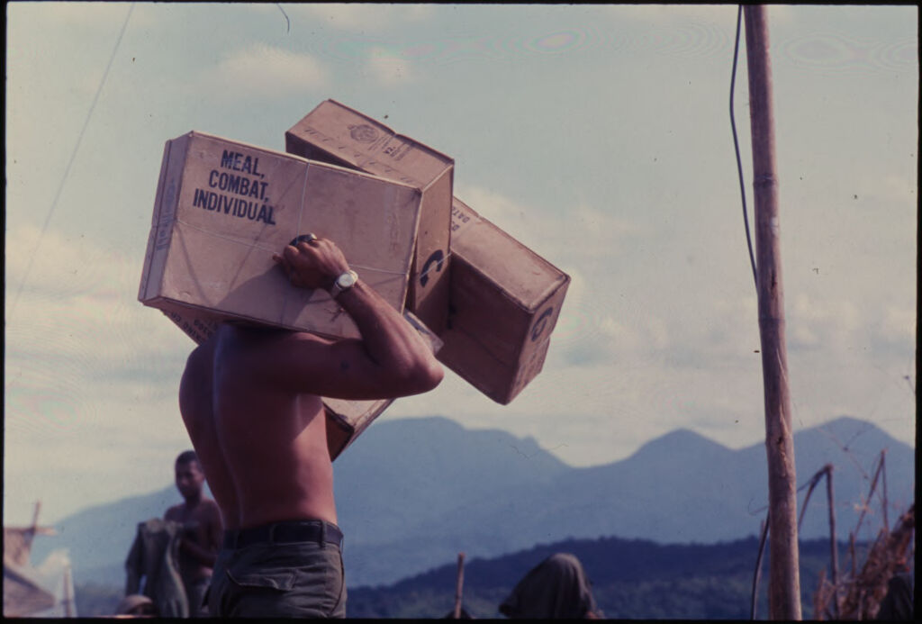 Untitled (Soldier Carrying Cargo Boxes On Shoulders, Vietnam)
