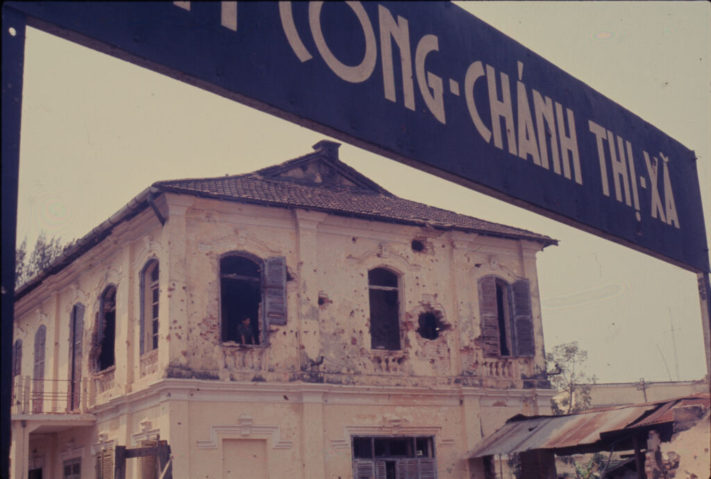 Untitled (Damaged Building Framed By Sign, Hue, Vietnam)