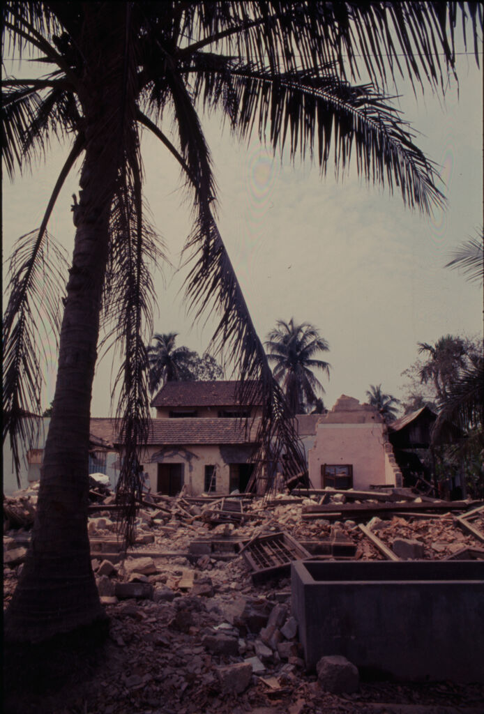Untitled (Damaged Building With Debris Piled In Front And Palm Tree In Foreground, Hue, Vietnam)