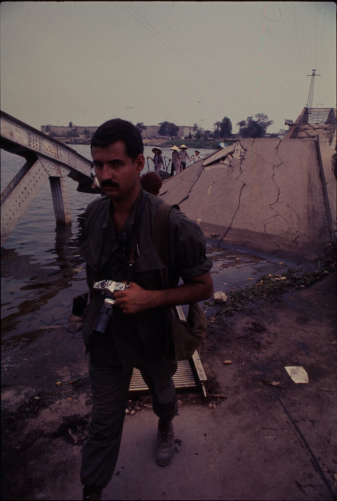 Untitled (Soldier With Camera Walking On Collapsed Bridge, Perfume River, Hue, Vietnam)