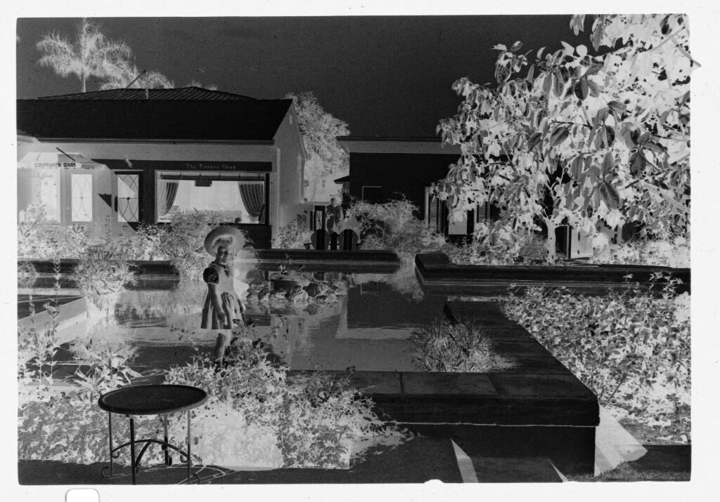 Untitled (Young Girl Standing On Ledge In Yard)
