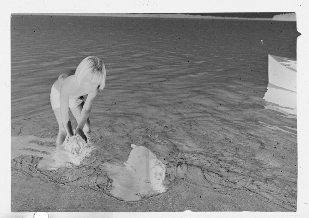 Untitled (Young Girl Playing With Puppies In Water)