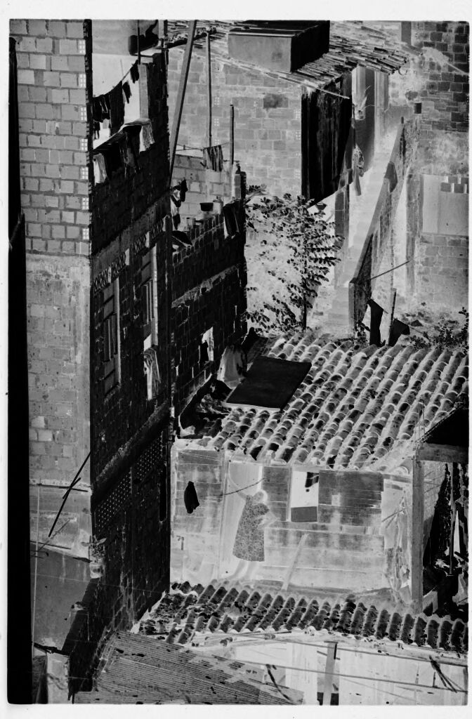 Untitled (Woman Standing Outside Ramshackle Building Lining Stepped Street)