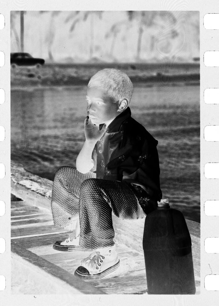 Untitled (Boy Sitting On Dock Next To Jug Of Water)