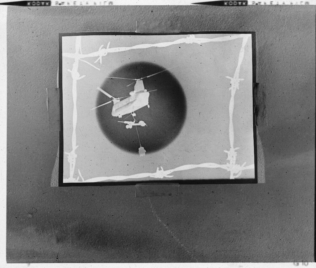 Untitled (Rephotograph Of Image Showing Chinook Helicopter Lifting 105Mm Howitzer Silhouetted Against Sun And Framed By Barbed-Wire Square)