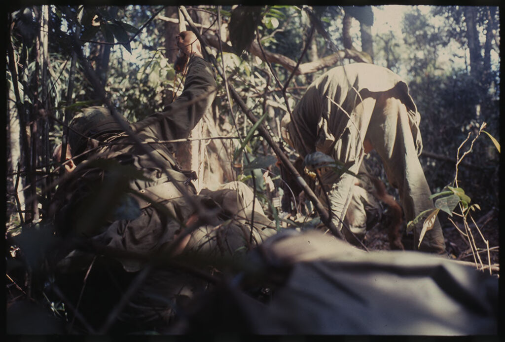 Untitled (Camouflaged Soldiers Taking Cover In Jungle During Fighting In Central Highlands Near Dak To, Vietnam)