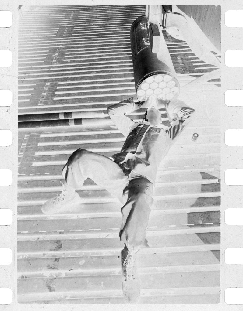Untitled (Soldier Lying On Back On Deck Looking Into Large Pipe, Vietnam)