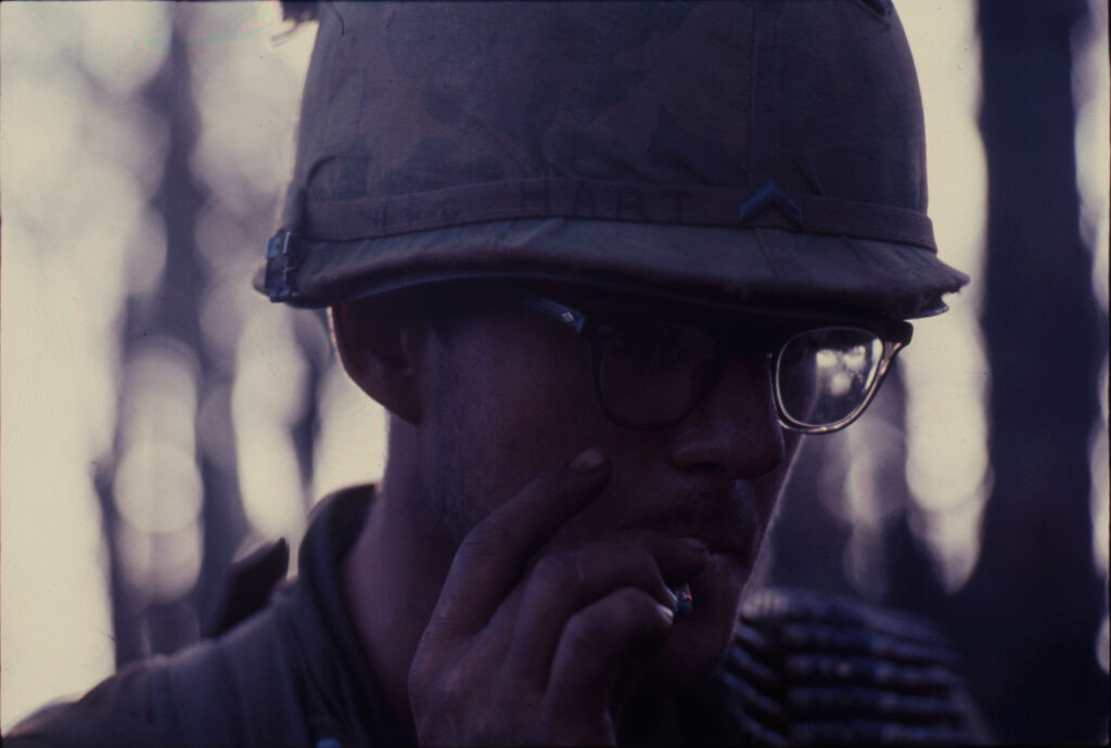 Untitled (Soldier In Helmet And Glasses Smoking Cigarette, Central Highlands Near Dak To, Vietnam)