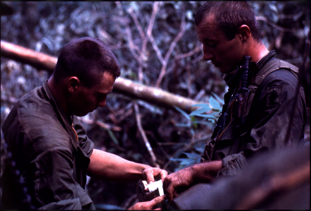 Untitled (Soldier Wrapping Another's Injured Hand During Fighting In Central Highlands Near Dak To, Vietnam)