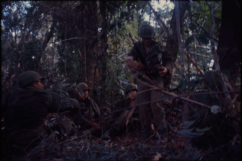 Untitled (Soldiers Sitting In Jungle During Fighting In Central Highlands Near Dak To, Vietnam)