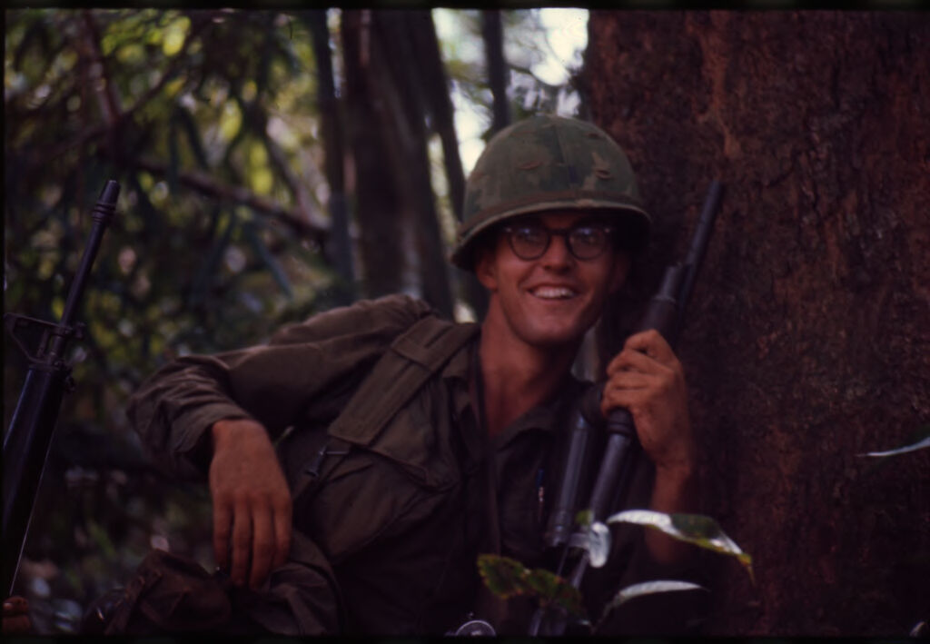 Untitled (Soldier Smiling At Camera During Patrol In Jungle, Central Highlands Near Dak To, Vietnam)