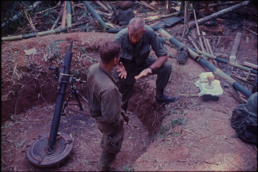 Untitled (Two Soldiers In Circular Ditch By Altar Set Up For Religious Service, Central Highlands Near Dak To, Vietnam)