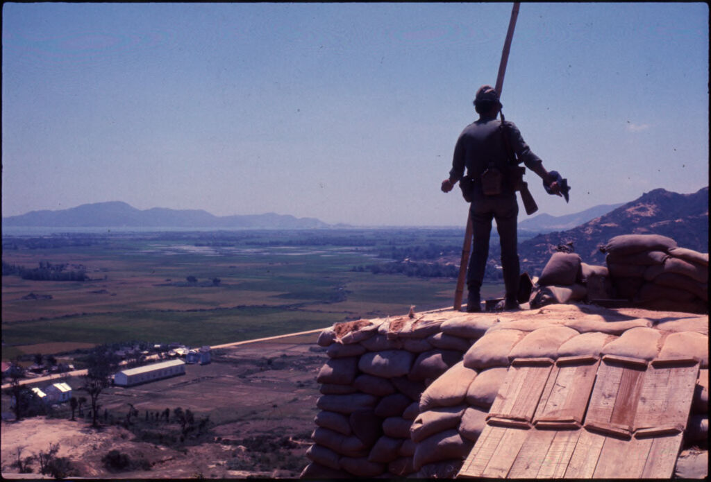 Untitled (Soldier Standing On Hilltop Overlooking Landscape, Vietnam)