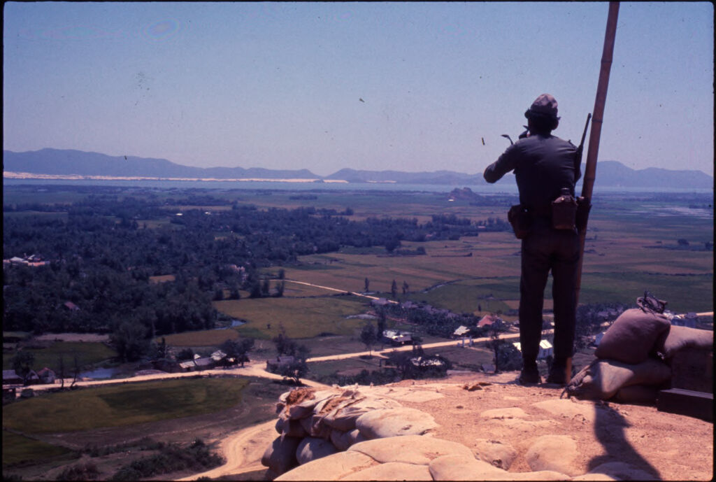 Untitled (Soldier Standing On Hilltop Overlooking Landscape, Vietnam)