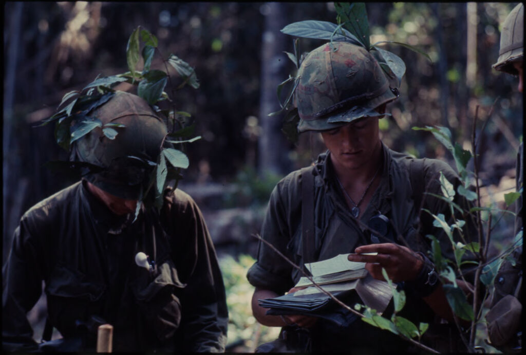 Untitled (Camouflaged Soldiers Examining Documents In Jungle Of Central Highlands Near Dak To, Vietnam)