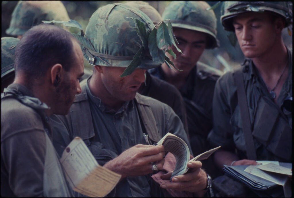 Untitled (Camouflaged Soldiers Examining Documents In Jungle Of Central Highlands Near Dak To, Vietnam)