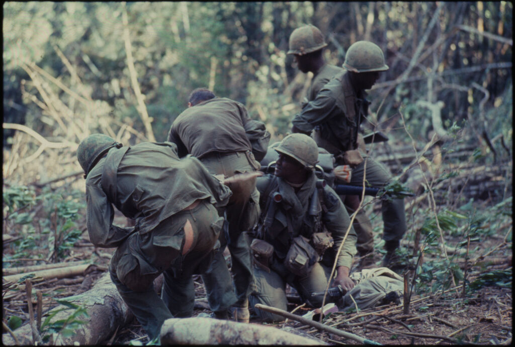 Untitled (Soldiers In Line Pulling Equipment Through Jungle, Central Highlands Near Dak To, Vietnam)