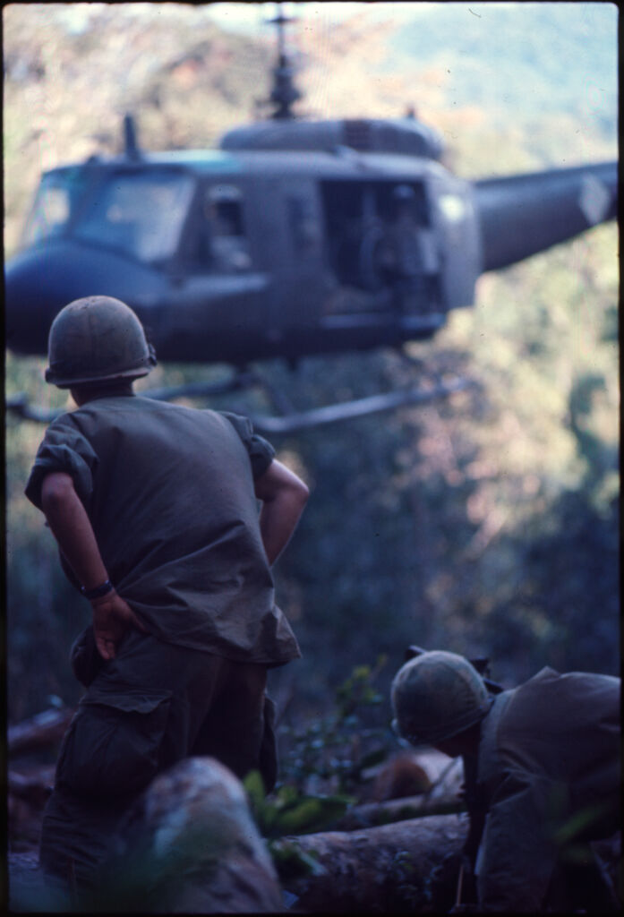 Untitled (Soldiers At Hilltop Landing Zone Watching Arrival Of Helicopter, Vietnam)