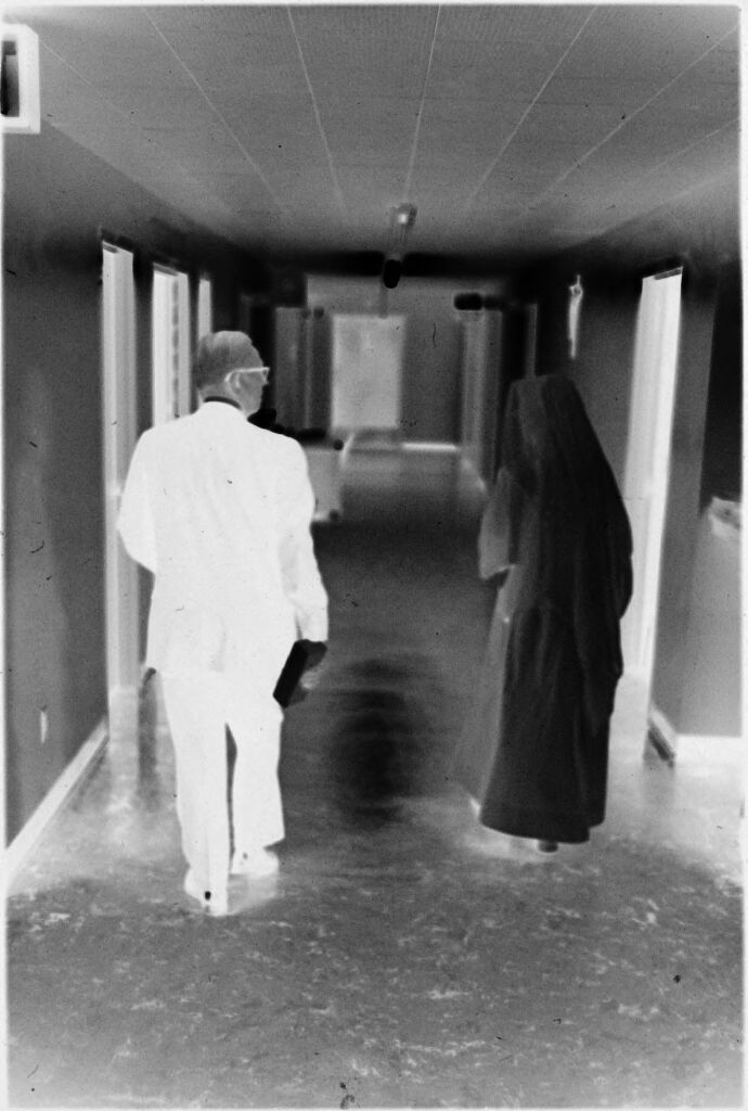 Untitled (Dr. Herman M. Juergens And Nun Walking Down Hallway)