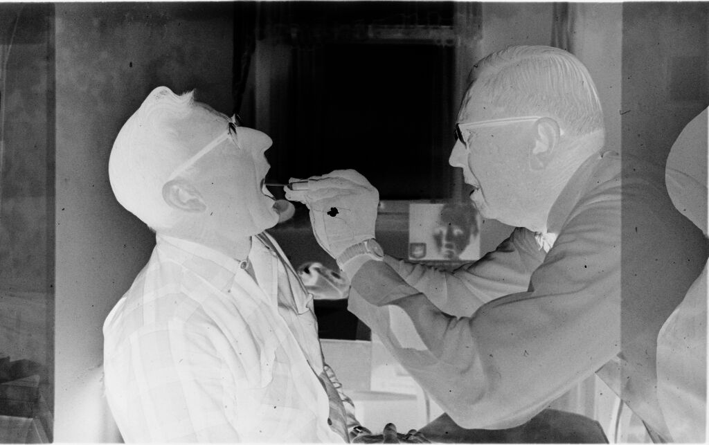 Untitled (Dr. Herman M. Juergens Examining Inside Of Patient's Mouth)