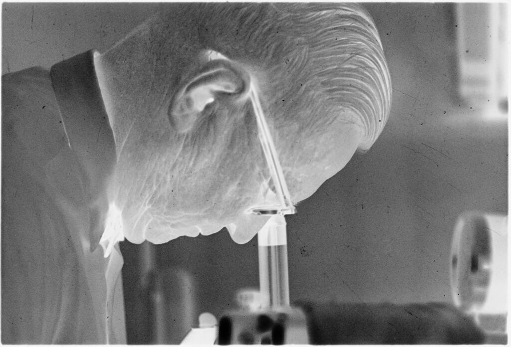 Untitled (Dr. Herman M. Juergens Looking Through Microscope)