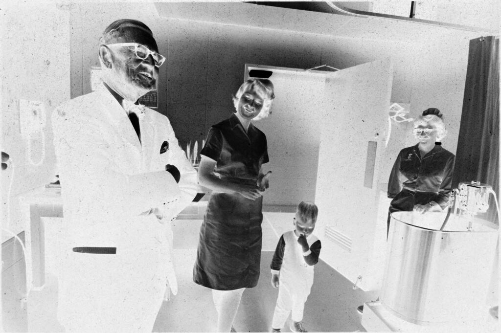 Untitled (Dr. Herman M. Juergens With Nurses And Toddler In Patient's Room)
